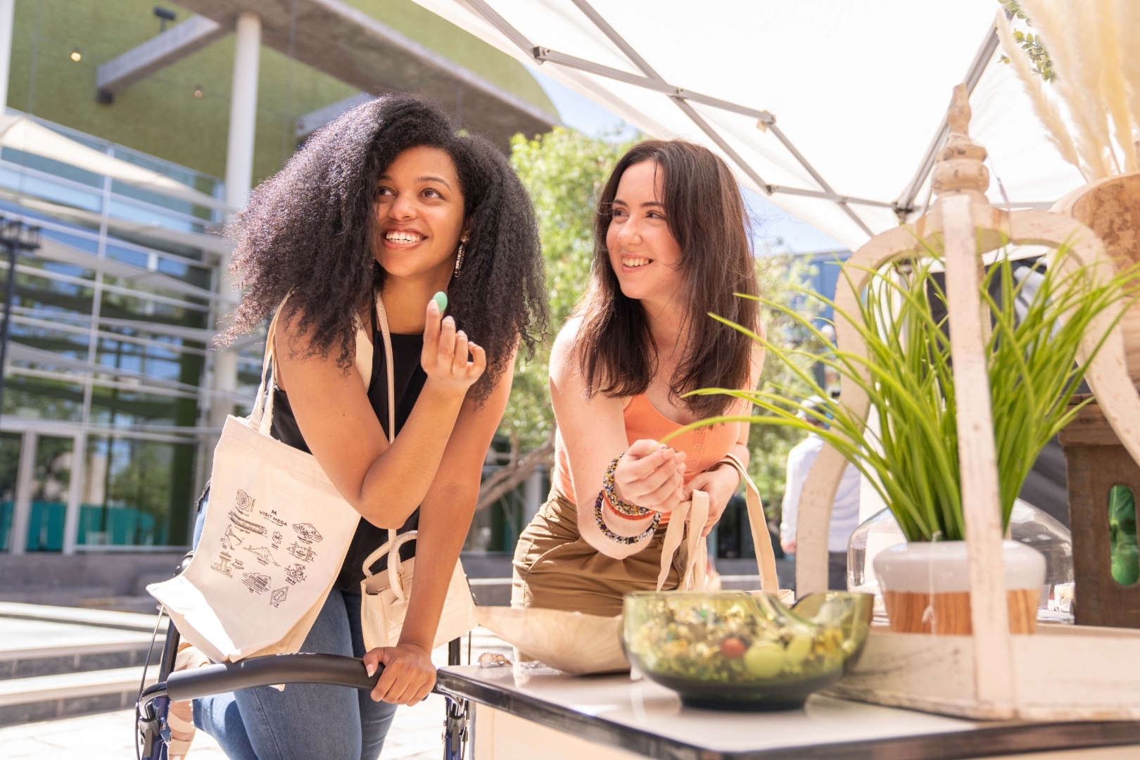 Visitors shopping at a farmers market in Mesa